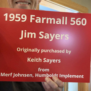 Order 715542 Review Image. Man holding up red plastic sign that says 1959 Farmall 560.