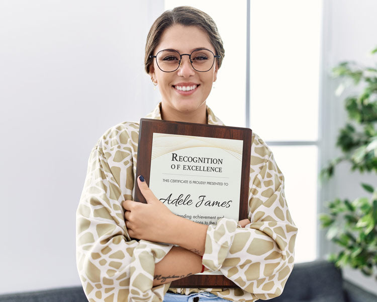 Woman holding a Custom 'Recognition of Excellence' plaque in an indoor setting