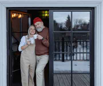 Old happy couple drinking coffee