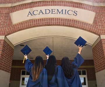 3 Women in Graduation Robes Celebrating
