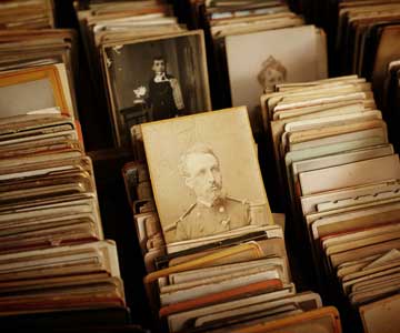 Large files with old photographs in them, focusing on one photo with a general.
