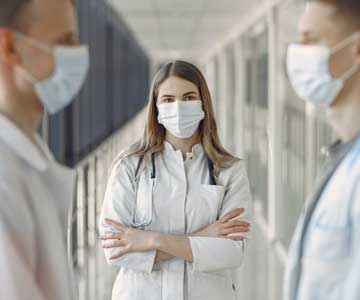 Woman Physician Listening to Colleagues
