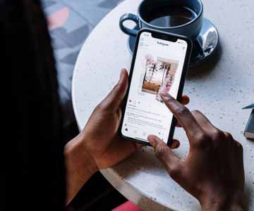 Person browsing a phone, focused.