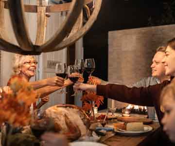 Family toasting with wine at Thanksgiving dinner.