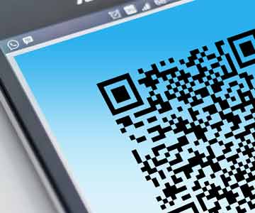 A close-up on a phone scanning a QR code.