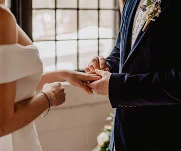 A couple exchanging rings at a wedding ceremony
