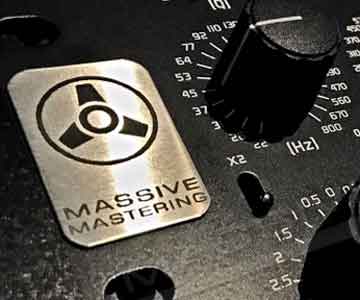 Stainless steel sign taped on massive audio mastering equipment.