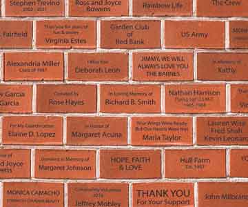 Bricked wall with a printed name on each brick.