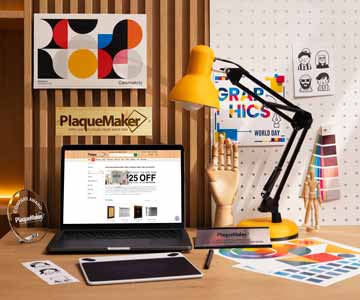 Custom Bamboo Sign With Rectangle Shape And PlaqueMaker Logo On Office Wall Above Work Desk With Laptop Showing PlaqueMaker