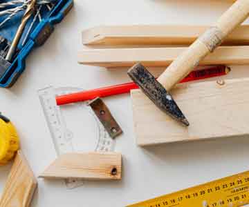 Carpenter tools neatly laid out on a desk.