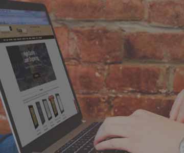 Person on a computer looking at the plaquemaker website