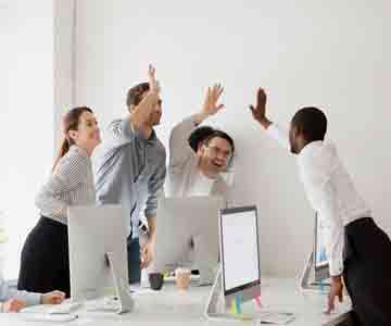 Team high-fives the boss with big smiles