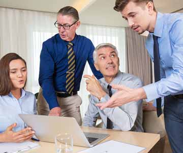 Group of co-workers talking to each other in a meeting.