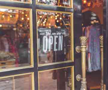 Business entrance with an "OPEN" sign displayed in the door.