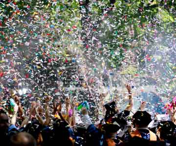 Students graduating with confetti all around.