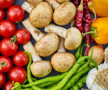 Different types of vegetables laying on a table.