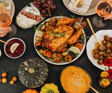 Decorated Table For Thanksgiving With A Large Perfectly Cooked Turkey