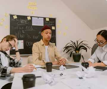 Inventors gathered around a desk