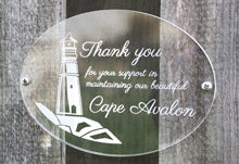 Frosted Engraving On A Clear Oval Acrylic Sign On Fence.