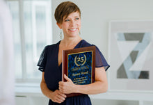 Custom Laser Engraved Aluminum Plaque For Retirement Held By Smiling Woman.