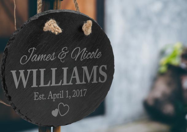 Personalized Slate Oval Sign Hanging At Wedding Celebration.
