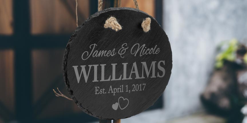 Personalized Slate Oval Sign Hanging At Wedding Celebration.