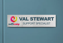 Custom Printed Silver Aluminum Office Name Plate On Blue Wall In Office.