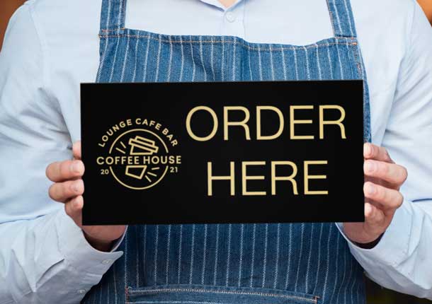 Laser Engraved Black Metal Aluminum Sign Held By Man In Apron