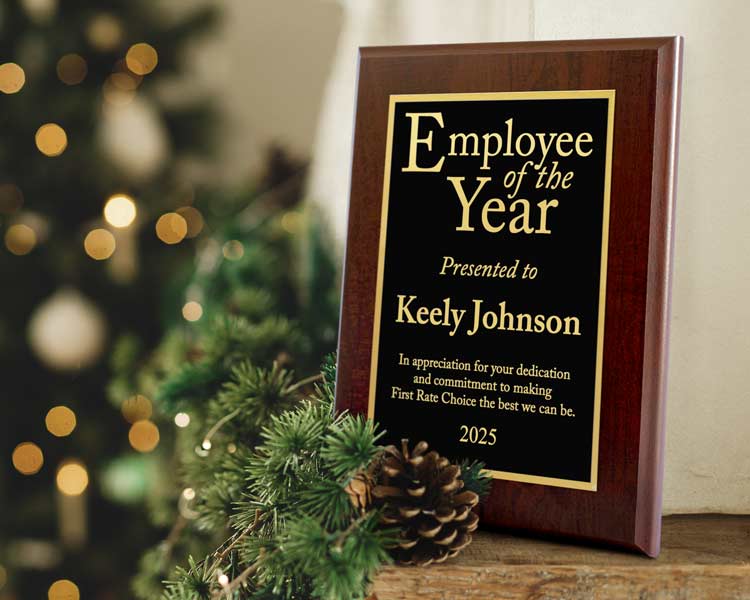 Custom Plaque titled 'Employee of the Year' presented to Keely Johnson with a Christmas tree in the background.
