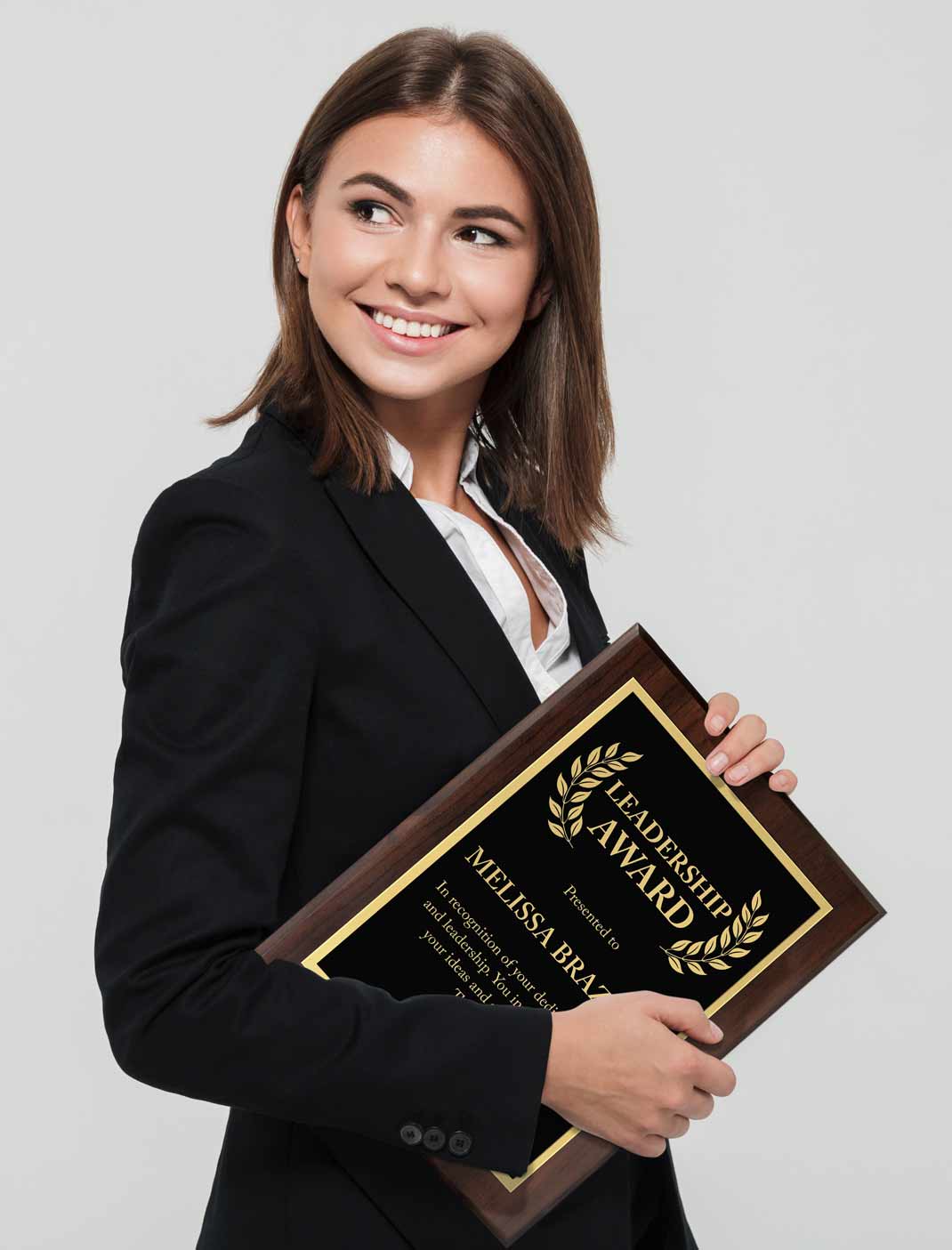 A woman in a black blazer holding a custom 'Leadership Award' laser engraved plaque against a light gray background