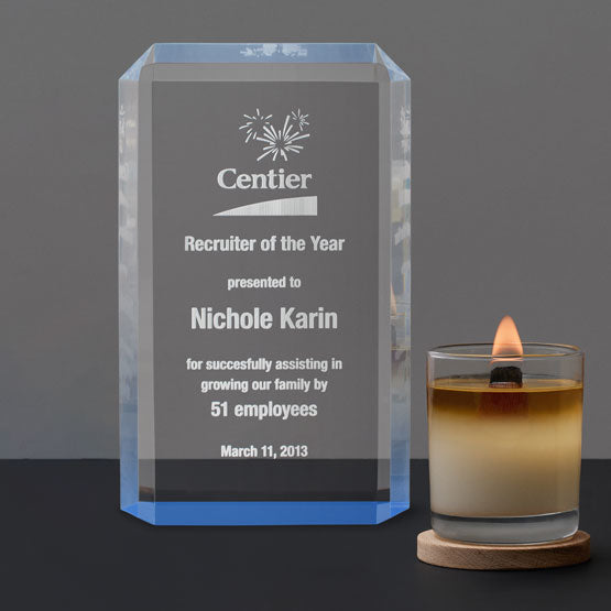 Standing Acrylic Award For Recruiter Of The Year With Clipped Corners And Faceted Edges And Blue Accent On Shelf With Candle