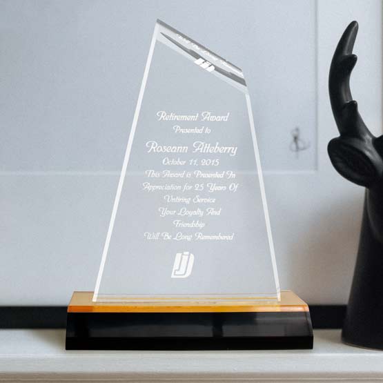 Custom Peak Tower Acrylic Award For Retirement With Name And Logo And Gold Mirror Base On Shelf With Black Deer Bust