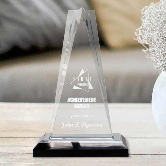 Custom Star Tower Acrylic Award For Employee Achievement With Silver Mirror Base On Wood Coffee Table With Vase Near Couch