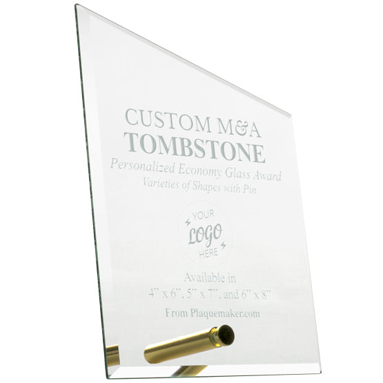 A custom M&A Tombstone glass award with a gold pin for mounting at the bottom, featuring engraved text and placeholder art against a white background.