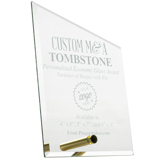 A custom M&A Tombstone glass award with a gold pin for mounting at the bottom, featuring engraved text and placeholder art against a white background.