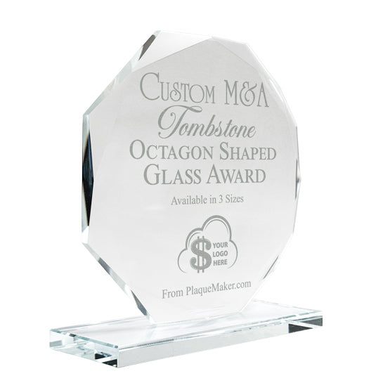 A clear octagonal glass award on a glass base, engraved with custom text and placeholder art, set at a slight angle and shown on a white background.