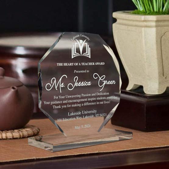 Custom Faceted Octagon Glass Award For Teacher With Glass Base Standing On Wood Work Desk With Teapot And Plant