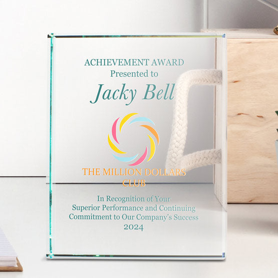 Custom Standing Rectangle Glass Award For Achievement With Full Color Logo And Name And Message On White Desk With Book