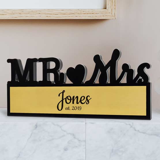 Custom Black Acrylic Sign With Mister And Missus Cutout And Metal Plate With Name And Date On Marble Countertop