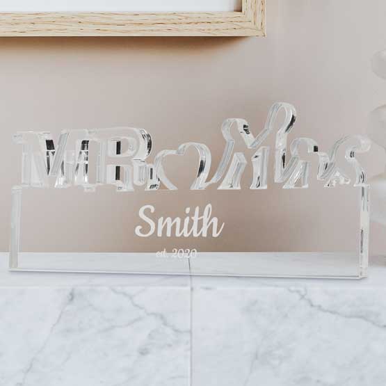 Custom Clear Acrylic Sign With Mister And Missus Cutout And Acrylic Rectangle With Name And Date On Marble Countertop