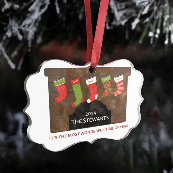 Custom Ornate Acrylic Ornament With Red Ribbon And Artwork Of Fireplace With Stockings And Family Names Hanging On Tree