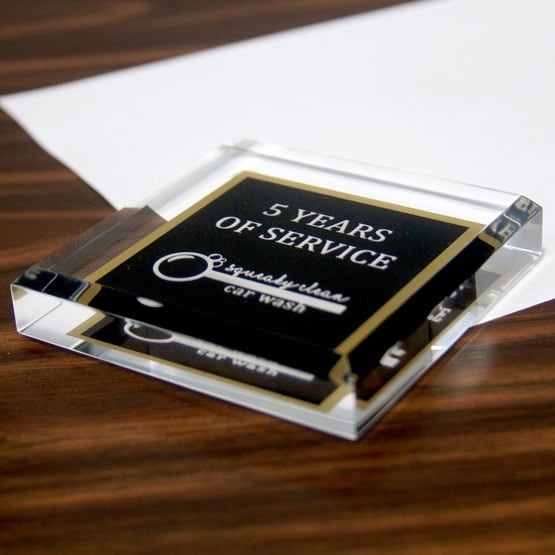 Custom Black And Gold Acrylic Paperweight Award For Years Of Service With Car Wash Company Logo On Wood Office Desk