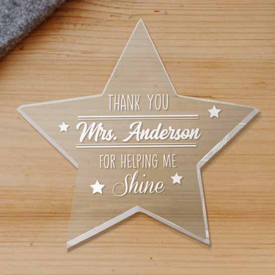 Custom Star Shaped Acrylic Paperweight With Teacher Name And Appreciation Message On A Wood Desk