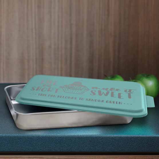 Custom Aluminum Cake Pan With Rectangle Shape And Teal Lid With Name And Baking Art And Message On Blue Kitchen Counter