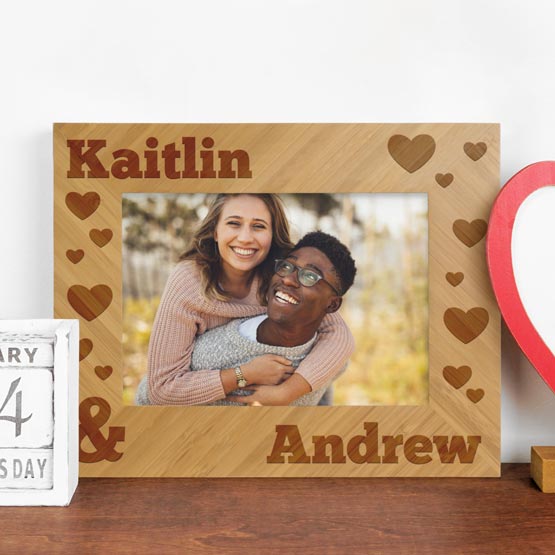 Custom Bamboo Picture Frame With Couple Photo And Engraved With Names And Hearts On Wood Dresser With Calendar