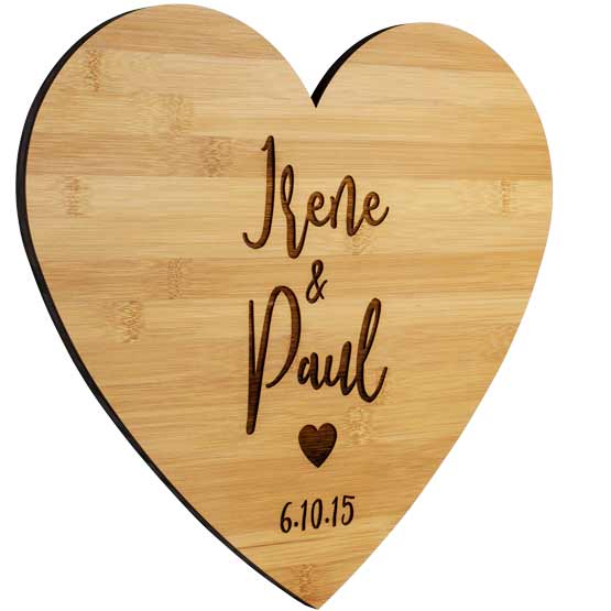 Custom Heart Shaped Bamboo Sign Laser Engraved With Couple Names And Date And Heart Artwork Against A White Background
