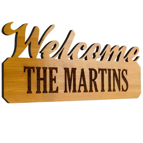 Custom Bamboo Sign With Welcome Cutout And Laser Engraved With The Martins Family Name Set Against White Background