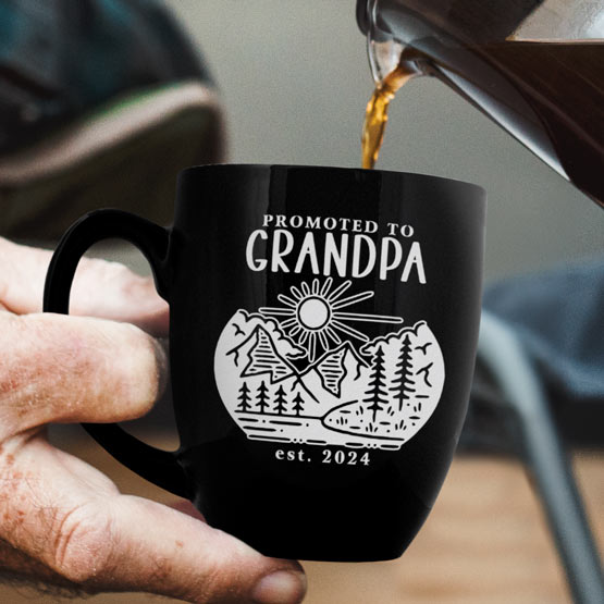 Man Hand Pouring Coffee Into Custom Black Ceramic Bistro Mug Engraved With Nature Artwork And Promoted To Grandpa Text