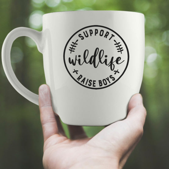 Hand Holding Up Custom White Ceramic Bistro Mug Laser Engraved With Support Wildlife Raise Boys Text Near Trees