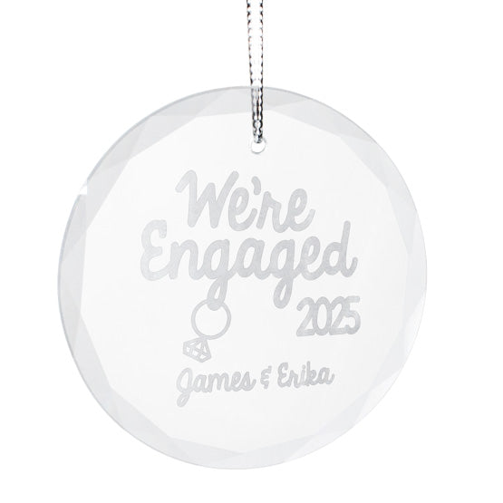 Custom Circle Glass Ornament With Silver String And Engraved With We’re Engaged Text And Date And Couple Names And Ring Art